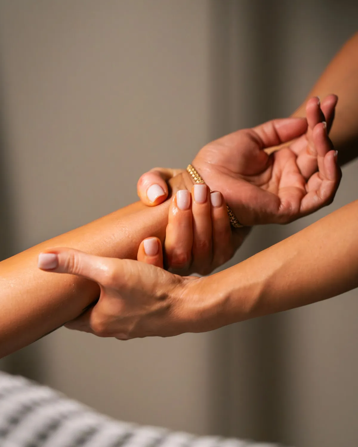 A practitioner's bare hands during a treatment